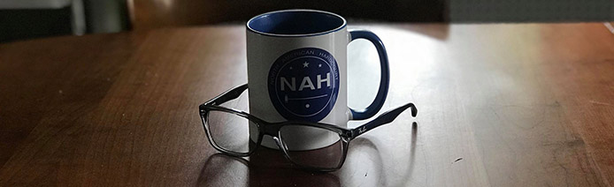 NAH coffee mug and glasses on a table